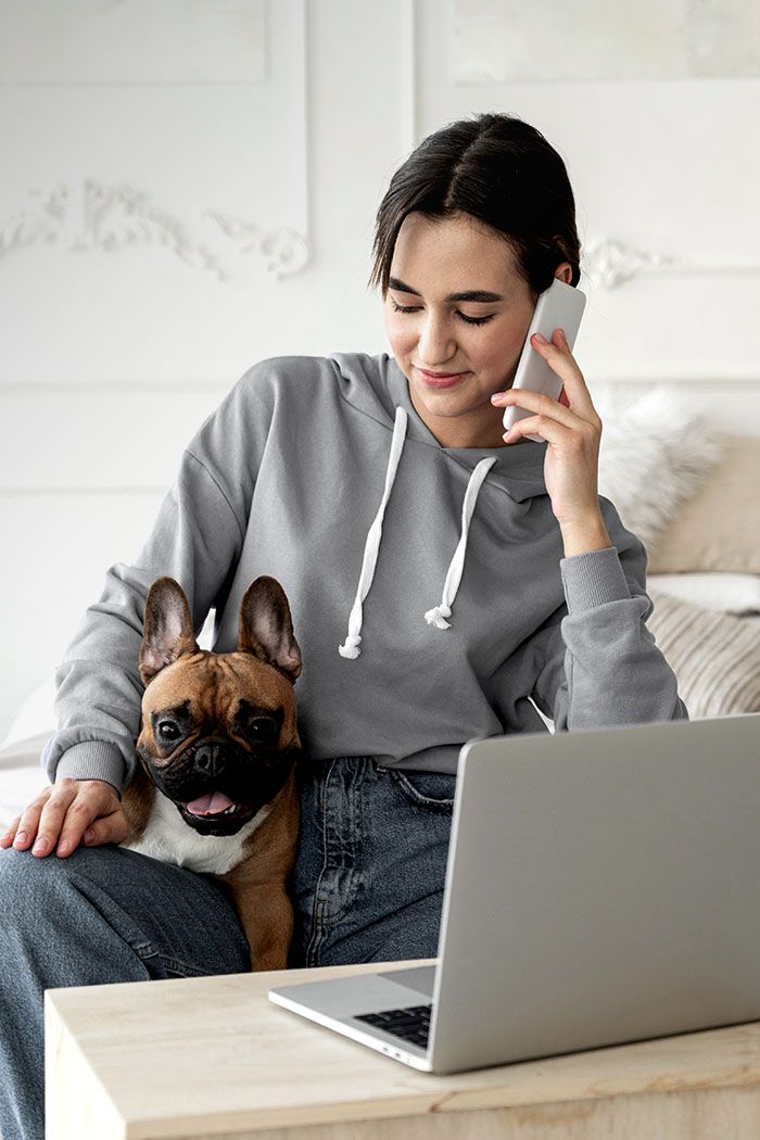 woman with dog talking phone
